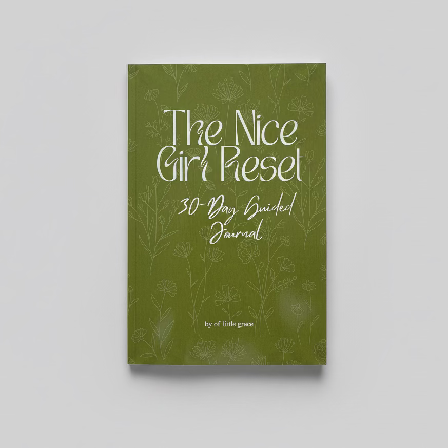 Green journal titled 'The Nice Girl Reset 30-Day Guided Journal' on a textured white surface