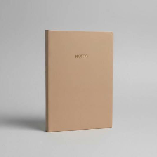 Beige notebook with 'NOTES' text on a gray background
